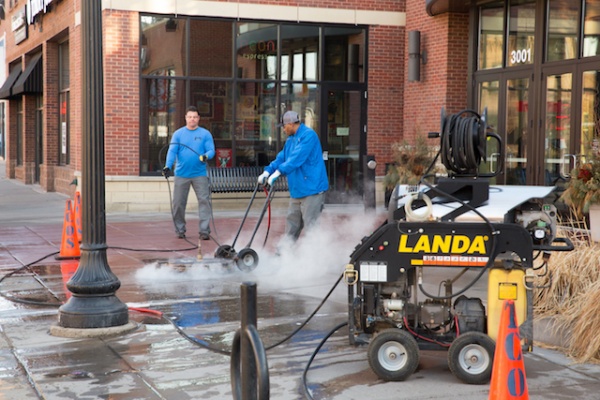 cleaning and sealing concrete at Calhoun Square in Minneapolis with hot water and big compressor